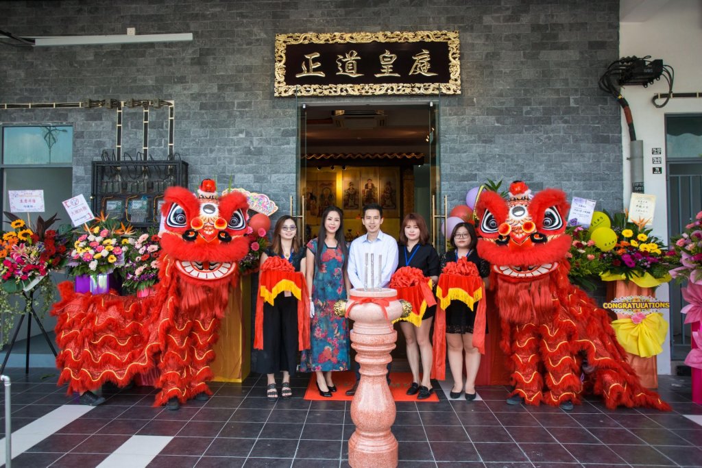 Group outside ZDHT premises with lion dance costumes and flowers