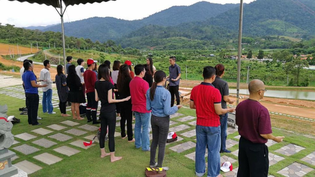 Outdoor group gathering with hills in the background